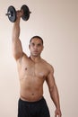 Weight trainer lifting dumbbell with one hand Royalty Free Stock Photo