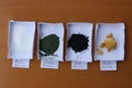 Weighted amounts of different minerals: white alumina, green chromium oxide, black iron oxide, yellow arsenic sulfide, with mass v