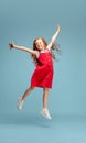 Happy redhair girl isolated on blue studio background. Looks happy, cheerful, sincere. Copyspace. Childhood, education