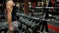 Weightlifter working out with big dumbbell in gym, preparing for competition Royalty Free Stock Photo