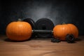 Gym dumbbell barbell with autumn pumpkins as a weight plates. Royalty Free Stock Photo