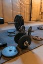 Weights and dumbbells in a dark moody home basement gym Royalty Free Stock Photo