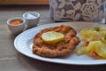 Weiner schnitzel with potato salad on a wooden background