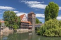 Weinstadle timbered building and Henkersteg or Hangmans Bridge reflected in Pegnitz River. Nuremberg, Bavaria, Germany Royalty Free Stock Photo