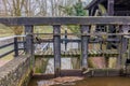 Weir with a structure to open the gates next to the Leumolen or Sint-Ursulamolen watermill Royalty Free Stock Photo