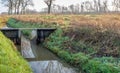 Weir of wood and metal in a small stream Royalty Free Stock Photo