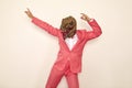 Crazy young guy wearing pink suit and funny dinosaur mask dancing and having fun at party Royalty Free Stock Photo