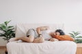 Weird and funny sleep pose of man in his apartment in boring day off.