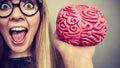 Weird woman holding brain having idea Royalty Free Stock Photo