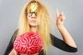 Weird woman holding brain having idea Royalty Free Stock Photo