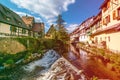 Weiss river in Kaysersberg, Alsace, on a sunny spring day. Colored Light leak filter applied Royalty Free Stock Photo