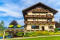 WEISSENSEE LAKE, AUSTRIA - JUL 6, 2015: Typical alpine guest house on green meadow in summer landscape of Weissensee lake, Austria