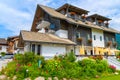 WEISSENSEE LAKE, AUSTRIA - JUL 6, 2015: Typical alpine guest house on green meadow in summer landscape of Weissensee lake, Austria