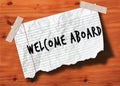 WELCOME ABOARD handwritten on torn notebook page crumpled paper on wood texture background. Royalty Free Stock Photo