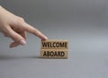 Welcome aboard symbol. Concept word Welcome aboard on wooden blocks. Beautiful grey background. Businessman hand. Business and Royalty Free Stock Photo