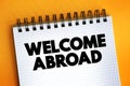 Welcome Abroad text on notepad, concept background