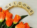 Welcome alphabet letters with tulip flower bouquet