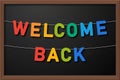 welcome back garland, colorful back to school bunting on black chalkboard background, vector illustration