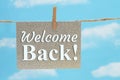 Welcome Back gray greeting card over blue sky Royalty Free Stock Photo