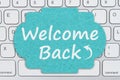 Welcome Back message on a sign on gray keyboard Royalty Free Stock Photo