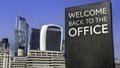 Welcome back to the office on a sign in front of the City of London