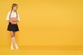 Welcome back to school. Inspirational quotes motivate kids for academic year ahead. School girl formal uniform hold book