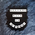 Welcome back to school lettering on blackboard. Back to school inscription on chalkboard. Message on chalkboard. Top View. Banner