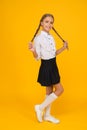 Welcome back to school. Small schoolgirl with happy smile. Little schoolgirl looking nice in school uniform. Cute