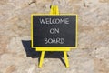 Welcome on board symbol. Concept words Welcome on board on black chalk blackboard on a beautiful stone background. Business, Royalty Free Stock Photo