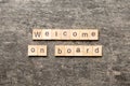 welcome on board word written on wood block. welcome on board text on table, concept