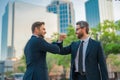Welcome business. Two businessmen shaking hands. Business men in suit shaking hands outdoors. Handshake between two Royalty Free Stock Photo