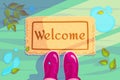 Welcome doormat with green leaves and rubber boots. Hello Spring season background. Horizontal concept