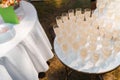 Welcome drink zone with champagne in disposable plastic wine cups. Many wine glasses on the white table. Catering for Royalty Free Stock Photo
