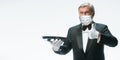 Elegance senior man waiter in protective face mask on white background. Flyer with copyspace.
