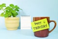 Welcome, hello and happy Thursday concept. Selective focus of coffee cup with green paper note.