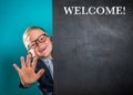 Welcome and hello. Portrait of smart school child with thumb up near blackboard blank and looking at camera. Happy kid Royalty Free Stock Photo