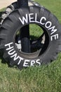 WELCOME HUNTERS painted on a large tractor tire
