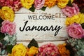 Welcome January text and Flowers Colorful Border Frame on wooden background
