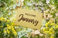 Welcome January text message with flower decoration on yellow background