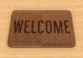 Welcome mat on wooden floor