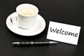 Welcome message on desk with coffee