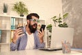 Welcome mobile ordering now. Crazy brutal hipster shouting at mobile phone in office. Bearded man with personal mobile