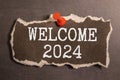 Welcome 2024 - New Year concept on a vintage slate blackboard isolated on white. Royalty Free Stock Photo