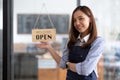 Welcome open shop barista waitress open sign on glass door modern coffee shop ready to serve restaurant cafe retail Royalty Free Stock Photo