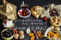 Welcome Ramadan writting by Turkish letters on the black background with foods.