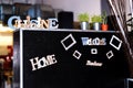 Welcome chalkboard in a restaurant with lettering and thyme seedlings