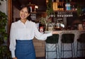 Welcome, restaurant waiter and business owner giving service with a smile at a coffee shop. Portrait of a black woman Royalty Free Stock Photo