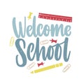 Welcome School inscription handwritten with elegant script and decorated by paper clips, push pins and ruler scattered