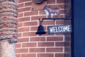 Welcome sign with black bell on pole Royalty Free Stock Photo