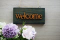 Welcome Sign and flower bouquet decoration on wooden background Royalty Free Stock Photo